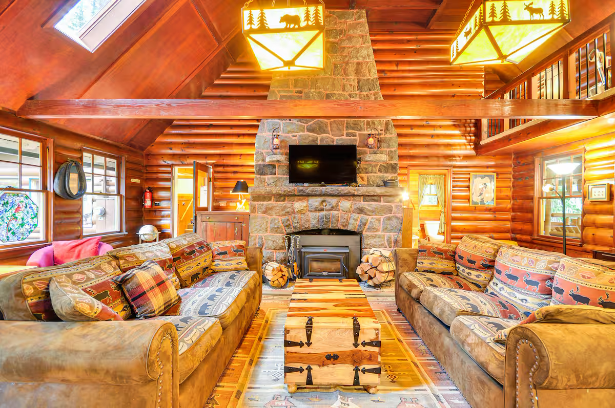 Minikahda Lodge interior — stone fireplace, log walls, rustic living room